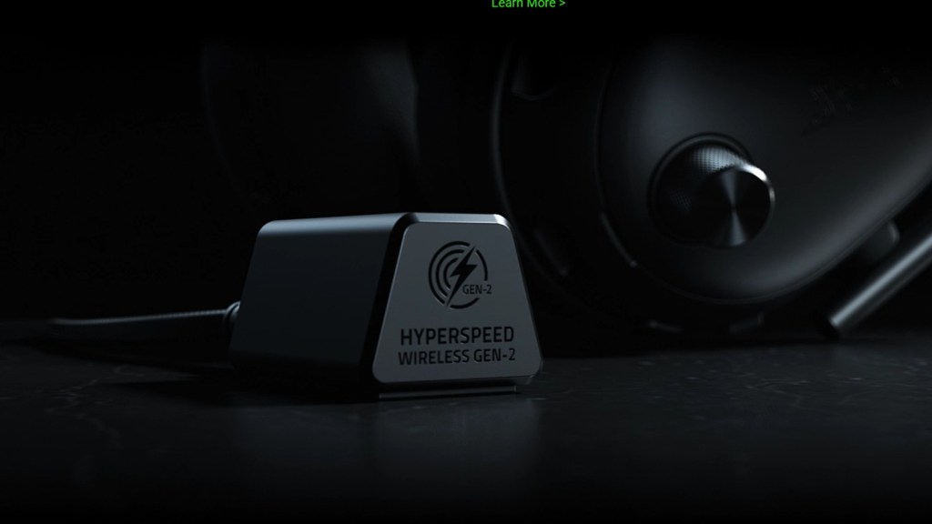 Close-up of a wireless receiver labeled 'HYPERSPEED WIRELESS GEN-2' beside a set of black headphones.